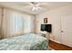 Bedroom featuring bright natural light, ceiling fan, and TV with stand at 4122 Central Sarasota Pkwy # 1923, Sarasota, FL 34238