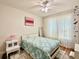 Bedroom featuring bright natural light, ceiling fan, and decorative bedspread at 4122 Central Sarasota Pkwy # 1923, Sarasota, FL 34238