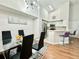 Bright dining area featuring a modern chandelier and an adjacent breakfast bar with sleek, purple bar stools at 4122 Central Sarasota Pkwy # 1923, Sarasota, FL 34238