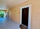 Exterior walkway with stucco walls, white trim and dark front doors at 4122 Central Sarasota Pkwy # 1923, Sarasota, FL 34238