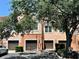 Townhome complex with attached garages, mature trees, and manicured landscaping at 4122 Central Sarasota Pkwy # 1923, Sarasota, FL 34238