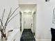 Hallway featuring a bathroom, a front door, and a laundry room with neutral paint at 4122 Central Sarasota Pkwy # 1923, Sarasota, FL 34238