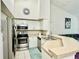 Bright kitchen with white cabinets, stainless steel appliances, and a breakfast bar at 4122 Central Sarasota Pkwy # 1923, Sarasota, FL 34238