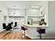 Modern kitchen with stainless steel appliances, bar seating, and open to dining area at 4122 Central Sarasota Pkwy # 1923, Sarasota, FL 34238