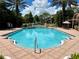 A bright blue community pool with an access ramp, fountains, and lots of seating at 4122 Central Sarasota Pkwy # 1923, Sarasota, FL 34238