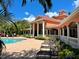 A resort style community pool with deck chairs and views of the community building at 4122 Central Sarasota Pkwy # 1923, Sarasota, FL 34238