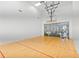 Indoor racquetball court with hardwood flooring, a viewing gallery, and a glass back wall at 4122 Central Sarasota Pkwy # 1923, Sarasota, FL 34238