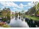 Scenic view of the pond with a fountain and lush landscaping surrounding the apartment buildings at 4122 Central Sarasota Pkwy # 1923, Sarasota, FL 34238