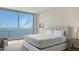 This spacious bedroom is furnished with a luxurious bed and offers stunning views of the water at 4123 Bay Shore Rd, Sarasota, FL 34234