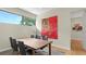 A modern dining room features seating for six and stylish artwork at 4123 Bay Shore Rd, Sarasota, FL 34234