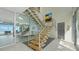 Elegant foyer featuring a modern staircase, elevator and floor to ceiling glass doors at 4123 Bay Shore Rd, Sarasota, FL 34234