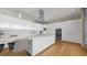Modern kitchen with stainless steel appliances, a large island, and beautiful hardwood floors at 4123 Bay Shore Rd, Sarasota, FL 34234