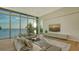 Bright and airy living room with expansive windows, comfortable seating and breathtaking views at 4123 Bay Shore Rd, Sarasota, FL 34234