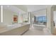 Spa-like bathroom with dual sinks, a soaking tub, and panoramic ocean views for ultimate relaxation at 4123 Bay Shore Rd, Sarasota, FL 34234