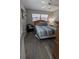 Bedroom featuring natural light, a chair, and wood laminate flooring at 4158 Tamiami Trl # V1, Port Charlotte, FL 33952