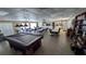 Spacious common area features a pool table, tables, and community kitchen at 4158 Tamiami Trl # V1, Port Charlotte, FL 33952