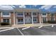 Brick exterior featuring white columns and ample parking at 4158 Tamiami Trl # V1, Port Charlotte, FL 33952