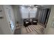 Cozy living room with neutral tones featuring wicker furniture, natural light, and laminate flooring at 4158 Tamiami Trl # V1, Port Charlotte, FL 33952