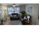 This is a comfortable living room featuring matching loveseats, laminate flooring, and natural light at 4158 Tamiami Trl # V1, Port Charlotte, FL 33952
