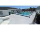Enjoy the community pool with lounge chairs on a sunny day at 4158 Tamiami Trl # V1, Port Charlotte, FL 33952