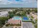 Overhead view showcasing a community pool, tennis courts, clubhouse, and ample parking at 425 30Th W Ave # C204, Bradenton, FL 34205