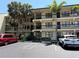 Condo building with three stories, black railings and tropical foliage at 425 30Th W Ave # C204, Bradenton, FL 34205