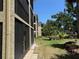 Building exterior featuring screened patios, tan stucco walls and meticulous landscaping at 425 30Th W Ave # C204, Bradenton, FL 34205