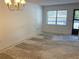 Living room with bright lighting and an entry doorway to the outside at 425 30Th W Ave # C204, Bradenton, FL 34205