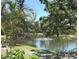 Scenic pond view with fountain, dock and mature trees at 425 30Th W Ave # C204, Bradenton, FL 34205