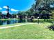Scenic view of a serene pond with fountain and gazebo, surrounded by lush greenery and condo buildings at 425 30Th W Ave # C204, Bradenton, FL 34205