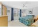 Comfortable bedroom with carpet, ceiling fan, and ample natural light from the large windows at 4519 14Th E St, Ellenton, FL 34222