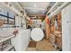 Functional laundry room with washer, dryer, storage shelves, and workbench area at 4519 14Th E St, Ellenton, FL 34222