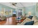 Comfortable living room has hardwood floors, plenty of natural light, and a ceiling fan at 4519 14Th E St, Ellenton, FL 34222