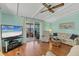 Bright living room features hardwood flooring, ceiling fan, and access to a screened lanai at 4519 14Th E St, Ellenton, FL 34222