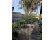 Tranquil backyard featuring a rock garden with a water feature, mature trees and privacy fence at 4700 Neptune Rd, Venice, FL 34293