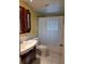 Bathroom featuring tile flooring, shower with shower curtain, single vanity, and custom cabinet at 4700 Neptune Rd, Venice, FL 34293
