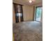 Bedroom with sliding doors, and window with blinds at 4700 Neptune Rd, Venice, FL 34293