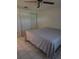 Bedroom featuring white tile flooring, a ceiling fan, and closet with sliding doors at 4700 Neptune Rd, Venice, FL 34293