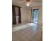 Bright bedroom featuring tile flooring, ceiling fan, and sliding door access to the outside at 4700 Neptune Rd, Venice, FL 34293