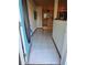 Entryway with light blue door, white tile flooring, and view into the open concept kitchen at 4700 Neptune Rd, Venice, FL 34293