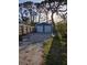 Detached two-car garage with brick paver driveway situated near a wooden privacy fence at 4700 Neptune Rd, Venice, FL 34293