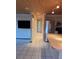 Hallway with white tile flooring connecting kitchen, living area, and other rooms at 4700 Neptune Rd, Venice, FL 34293