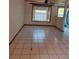 Bright Living Room with white tile flooring and large window with natural light at 4700 Neptune Rd, Venice, FL 34293