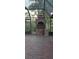 Outdoor brick fireplace on a brick patio within a screened-in enclosure at 4700 Neptune Rd, Venice, FL 34293