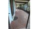 Covered outdoor patio featuring brick pavers, screen enclosure, and access to backyard at 4700 Neptune Rd, Venice, FL 34293