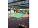 Enclosed pool with brick patio, ladder access, and an adjacent building with a door to the pool area at 4700 Neptune Rd, Venice, FL 34293