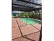 Screened in pool with brick patio, lush greenery, and ladder access to a clear, clean pool at 4700 Neptune Rd, Venice, FL 34293