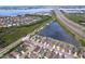 This aerial photo shows houses near a large pond, highway, and waterfront, highlighted by an orderly street design at 4826 San Ortebello Dr, Bradenton, FL 34208