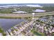 Aerial view displays a residential area near a highway and waterfront, featuring orderly streets and consistent home styles at 4826 San Ortebello Dr, Bradenton, FL 34208
