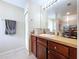 Well-lit bathroom vanity with wood cabinets, neutral countertop, and chrome fixtures at 4826 San Ortebello Dr, Bradenton, FL 34208